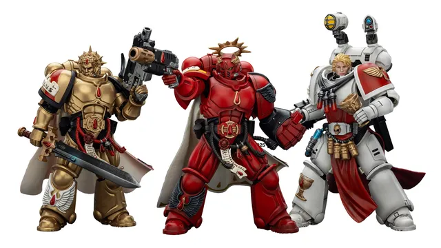 Three action figures representing Blood Angels Space Marines stand side by side. The first figure on the left is clad in red armor, holding a gun, and features intricate detailing. The central figure, also in red, has a prominent golden halo and a cape, while the figure on the right wears white armor with red accents and is equipped with various accessories, including a holstered weapon and a mechanical arm.