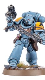 A Space Wolf Blood Claw miniature stands in a dynamic pose, wielding a chainsword in one hand and a pistol in the other. The miniature is painted in a striking blue color with yellow shoulder pads, showcasing intricate details and textures. It is mounted on a round base with a grassy terrain effect, emphasizing its role in the Warhammer 40,000 universe.