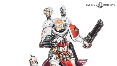 Miniature of a space marine in white and red armor holding a chainsword and gun, with a servitor and skull.