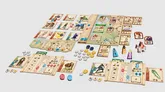 Board game "Greylune" with scattered cards showing characters, items, and maps. Wooden board pieces with icons, tokens in colors blue, yellow, red, and gray. Small figurines of people and animals. Text on cards includes "Greylune," "quests," and symbols like swords and shields.