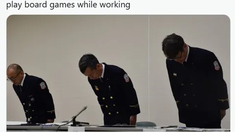 Three firefighters in uniform are bowing their heads in a formal setting, likely during a press conference or disciplinary meeting. The two on the left are wearing dark blue uniforms with badges, while the one on the right has a slightly different posture, suggesting a moment of reflection or apology. The background is neutral, focusing attention on the individuals and their solemn demeanor.