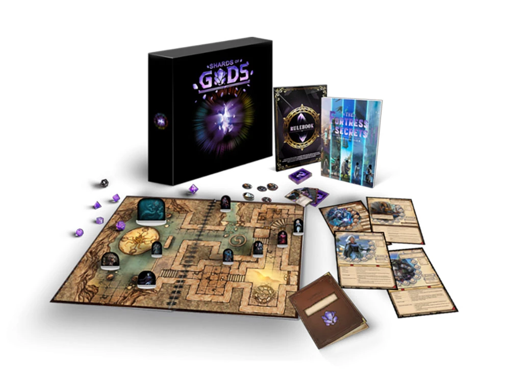 A boxed set titled "Shards of Gods" is prominently displayed, featuring a vibrant design with a central purple gem motif. Surrounding the box are various game components, including a detailed battle map with intricate pathways and tokens, a rulebook, and an adventure book titled "The Fortress Secrets." Additionally, several character sheets and game tokens are scattered around, showcasing the game's modular elements and character options.