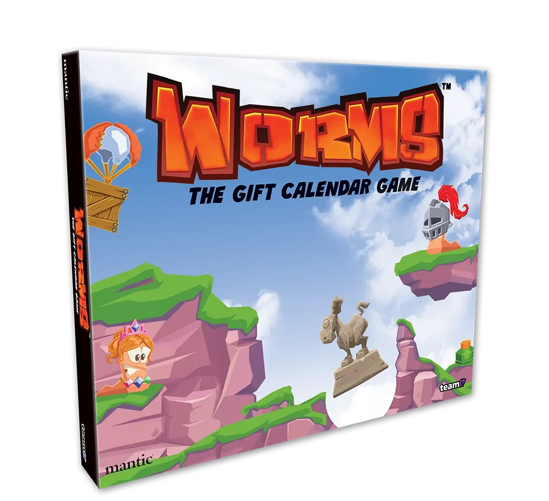 A colorful box for "Worms: The Gift Calendar Game" features a vibrant illustration of cartoonish landscapes with green hills and rocky cliffs. Prominent characters include a pink worm wearing a crown and a knight, both positioned on the cliffs, while a hot air balloon floats in the sky. The title is boldly displayed at the top, emphasizing the festive theme of the advent calendar.