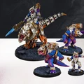 A dynamic scene features a group of colorful, sci-fi lizardmen from the Saurian Starhost army, showcasing their unique designs and vibrant colors. The central figure is a larger lizardman mounted on a dinosaur-like creature, equipped with futuristic armor and a glowing blue weapon. Surrounding them are smaller lizardmen, each adorned with mechanical enhancements and distinctive armor, all set against a textured black base that adds depth to the display.