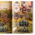 A vibrant spread showcases the new Grand Cathay faction, featuring a variety of intricately detailed miniatures. Prominent in the scene is a large armored figure wielding a weapon, alongside several smaller units adorned in teal and gold, with one character flying on a dragon-like creature. Above, two ornate hot air balloons with decorative patterns float, adding a fantastical element to the lush, green backdrop.