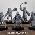 A group of five Drudge Slayer miniatures stands on circular bases, each showcasing unique designs and weaponry. The figures are muscular and armored, featuring various mechanical elements and menacing expressions. They are posed in dynamic stances, with some wielding large weapons like spiked flails and others displaying intricate details in their armor, all rendered in a gray color that highlights their features against a simple background.