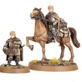 A miniature figure of Lief, a page from Rohan, stands beside a mounted version of himself on a brown horse. The standing figure is dressed in a green and brown cloak, holding a satchel, while the mounted figure wears similar attire and holds the reins of the horse. Both figures are set on a base with tufts of grass and small rocks, emphasizing their connection to the Rohan landscape.