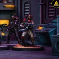 A detailed scene features three miniature figures from the Star Wars: Shatterpoint game, set against a futuristic backdrop with dark, industrial elements. On the left, a character in a flowing cloak stands poised, while the center figure, dressed in tactical gear, holds a blaster. The third figure, wearing a red and beige outfit, is equipped with a weapon and stands on a rocky base, with a control panel visible in the background. The overall color scheme includes dark tones with hints of vibrant colors, enhancing the sci-fi atmosphere.