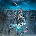 A dynamic miniature of a warrior from the Idoneth Deepkin, poised mid-action atop a swirling wave of water. The figure is adorned in intricate blue armor with a horned helmet, wielding a curved sword in one hand and a spear in the other. In the foreground, two sea serpents emerge from the wave, their heads raised, adding to the sense of movement and energy in the scene, set against a backdrop of dark, stormy skies and ancient stone architecture.