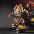 Two Lupine Shifted werewolves are depicted in the image, showcasing their fierce and muscular forms. Each werewolf has a distinctive fur pattern, with shades of brown and cream, accented by red markings on their faces and bodies. They stand on textured bases adorned with tufts of grass, emphasizing their wild nature and connection to the Old Umbrey region.