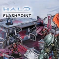 A detailed gaming scene from Halo: Flashpoint features a futuristic battlefield with intricately designed terrain and structures. In the foreground, a blue-armored character stands on a raised platform, while two red-armored figures engage in action nearby. The backdrop showcases a variety of buildings with sci-fi elements, emphasizing the game's immersive environment. The title "HALO FLASHPOINT" is prominently displayed at the top.