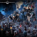 A dramatic scene showcases two imposing Chaos Knights, the Knight Ruinator and Knight Abominant, towering over a battlefield littered with detailed miniatures. The Knights feature intricate designs, with one adorned in dark metallic colors and the other showcasing a mix of blue and gold accents. Surrounding them are various smaller figures in red cloaks, wielding weapons, set against a backdrop of gothic ruins and atmospheric lighting.