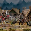 A detailed scene features Helm Hammerhand, King of Rohan, depicted both mounted on an armoured horse and on foot, alongside several Rohirrim warriors. The figures are intricately painted, showcasing vibrant colors and detailed armor, set against a backdrop of rustic wooden structures resembling Rohan architecture. The environment includes rocky terrain and hints of mountainous scenery, enhancing the thematic setting of the Middle-earth Strategy Battle Game.