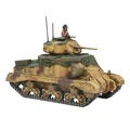 A detailed model of the M3 Grant medium tank, featuring a camouflage paint scheme with shades of green and brown. The tank has a prominent turret with a circular insignia and a figure of a soldier wearing a helmet, positioned on top. The model showcases intricate details, including the tracks and various components, emphasizing its design as a WWII U.S. vehicle.