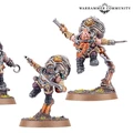 Three Kharadron Overlords miniatures are displayed, showcasing their distinctive nullsuits and gear. The figures include a dwarf with a cutlass and a pistol, another wielding a firearm, and a third with a mechanical arm, all posed dynamically as if in mid-action. The bases feature tufts of grass and rocky terrain, enhancing the adventurous theme of these flying duardin.