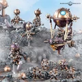 A group of intricately designed Kharadron Overlords miniatures is displayed on a rocky terrain, showcasing their steampunk aesthetic. The figures, featuring metallic colors of bronze and gold, include various duardin in nullsuits, armed with cutlasses and pistols, alongside a dirigible airship hovering above. Crystals and rocky formations add depth to the scene, enhancing the adventurous theme of these flying dwarves.