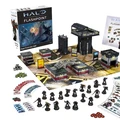 A boxed set for Halo: Flashpoint titled "Feet First into Hell" is prominently displayed, featuring artwork of soldiers in combat. Surrounding the box are 18 detailed miniatures of Orbital Drop Shock Troopers, along with a play mat depicting an urban warzone, several buildings, and various game components including dice, tokens, and cards. The scene is organized, showcasing the miniatures in a dynamic layout, emphasizing the tactical elements of the game.