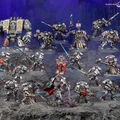 A detailed display of Black Templar miniatures showcases a variety of armored figures in silver and black, set against a dark, rocky backdrop. Prominent in the scene is a Venerable Dreadnought on the left, flanked by a mix of characters including the Emperor’s Champion, Bladeguard Veterans, and Sword Brethren, all wielding swords and other weapons. The figures are intricately painted, with some holding banners and others poised for battle, creating a dynamic and imposing presence.