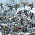 A dynamic scene showcases a variety of tabletop miniatures set against a snowy, rocky terrain. Prominent figures include Space Wolves in blue armor with yellow accents, wielding various weapons, alongside a few fierce-looking characters with distinct features and armor details. The composition highlights a mix of infantry and larger models, creating a sense of action and readiness for battle.