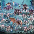 A dynamic scene showcases a Tyranid Assault Brood, featuring a variety of menacing xenomorph figures. In the foreground, ten rapid Genestealers are poised for action, flanked by three armored Tyrant Guard, while a Biovore and a Parasite of Mortrex add to the threatening presence. The backdrop features an eerie, underwater-like environment with vibrant colors and organic shapes, enhancing the overall atmosphere of impending danger.
