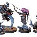A collection of miniatures from the Voidsea campaign features a variety of fantastical characters. On the left, a large, muscular humanoid figure with blue skin and a rugged outfit stands in a dynamic pose. Next to it, a slender, dark-skinned character with a jellyfish-like head holds a weapon, adorned in tattered clothing. To the right, a small, blue creature with a mischievous expression stands on a wooden base, while another figure with a claw and a menacing stance completes the lineup. The miniatures are intricately detailed, showcasing a mix of pirate and eldritch themes.