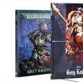Two codex books are displayed side by side. On the left, the "Codex Grey Knights" features a blue cover with an illustration of a Grey Knight in armor wielding a sword, set against a backdrop of a battle scene. On the right, the "Codex Grey Knights" has a darker cover showcasing a powerful Grey Knight in a striking pose, holding a weapon, with vibrant colors highlighting the artwork. Both books are designed for the Warhammer 40,000 tabletop game, with the titles prominently displayed.