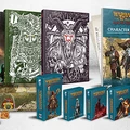 A collection of items from the forthcoming Warhammer: the Old World roleplaying game is displayed prominently. In the background, two large hardback books, the Player's Guide and Gamemaster's Guide, feature intricate cover art, while a character sheet pad is visible to the right. In the foreground, various reference card packs and a set of dice are arranged neatly, showcasing their colorful designs and thematic artwork.