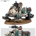 A compact, light vehicle known as a Kapricus is depicted, featuring distinctive anti-grav repellers and curved armor panels. It is equipped with a twin magna-coil autocannon and has a seated figure operating the weapon, showcasing a rugged design with mechanical details and a green and beige color scheme. The base is adorned with small rocks and grass, enhancing the vehicle's battlefield aesthetic.