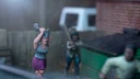 A dynamic scene features three miniature figures in a tense urban setting. In the foreground, a woman with blue hair raises a shovel, while a second figure behind her holds a baseball bat, both appearing ready to confront a threat. A third figure, dressed in a light shirt and blue pants, is seen running away, adding to the sense of urgency in the scene, with a green dumpster and a wooden fence in the background.