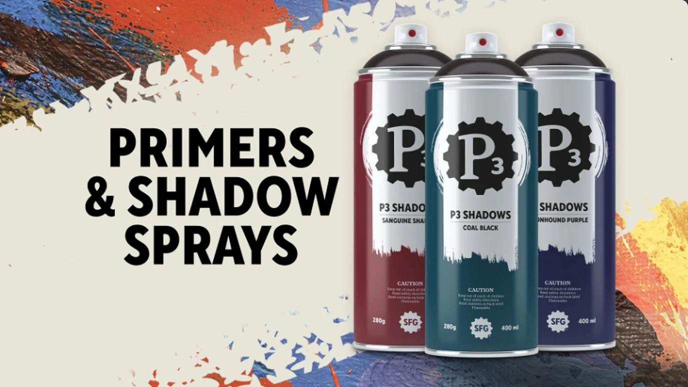 A spray can labeled "P3 SHADOW SPRAYS" in bold black text is prominently featured on a light background, with the specific shade "SANGUINE SHADOW" indicated. Surrounding the can are splashes of vibrant colors, including blue, red, and white, creating an artistic backdrop. The text "PRIMERS & SHADOW SPRAYS" is displayed above the can, emphasizing the product's focus on painting supplies for tabletop gaming.