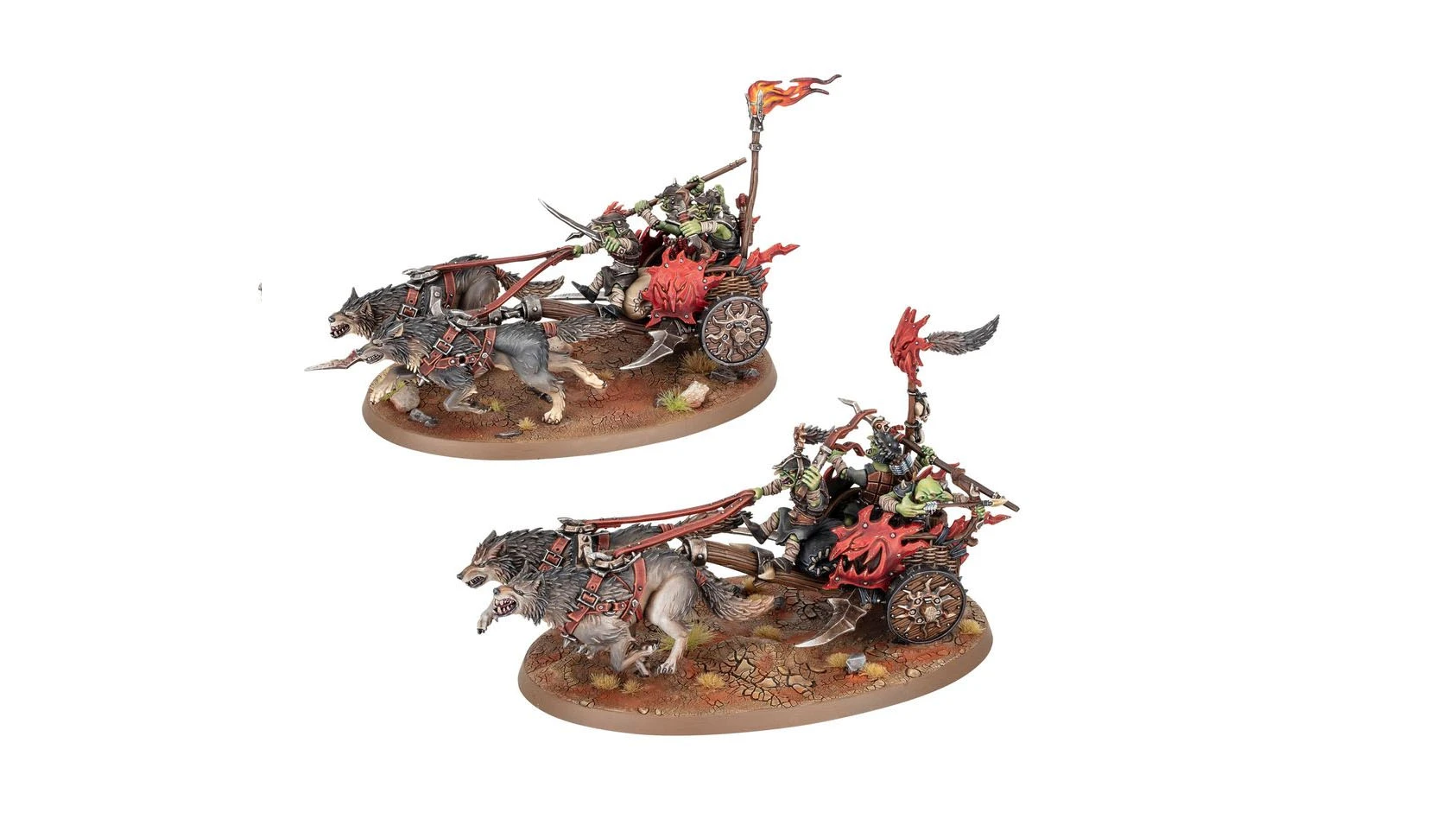 A dynamic scene features two chariots pulled by fierce wolves, each driven by goblin riders. The chariots are adorned with menacing details, including a flame-topped banner and a red, spiked front. The base is textured with earthy tones and scattered vegetation, enhancing the rugged, battle-ready aesthetic of the miniatures.