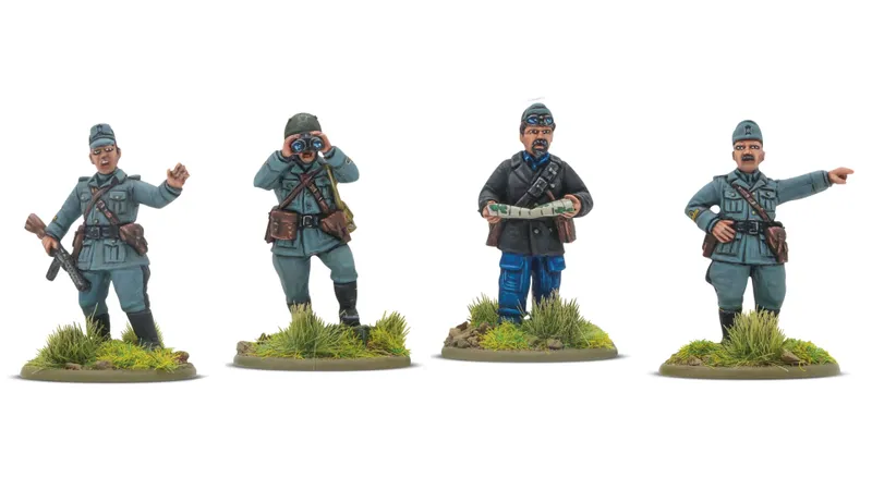 Four 28mm scale miniatures are displayed, representing different military figures. From left to right, a soldier in a green uniform holds binoculars, a second soldier in a blue uniform is looking at a map, a third figure in a dark coat appears to be issuing commands, and the last figure stands with a serious expression. Each miniature is mounted on a base with tufts of grass and small rocks, enhancing the realistic battlefield setting.