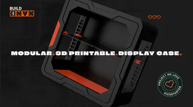 A sleek, 3D-printable display case designed for collectors, featuring a black exterior with angular lines and a vibrant red base. The case is shown from a slightly elevated angle, highlighting its modular design and snap-fit assembly, which requires no tools. The text "3D-PRINTABLE. DISPLAY CASE." is prominently displayed, along with a "PROJECT WE LOVE" badge from Kickstarter.