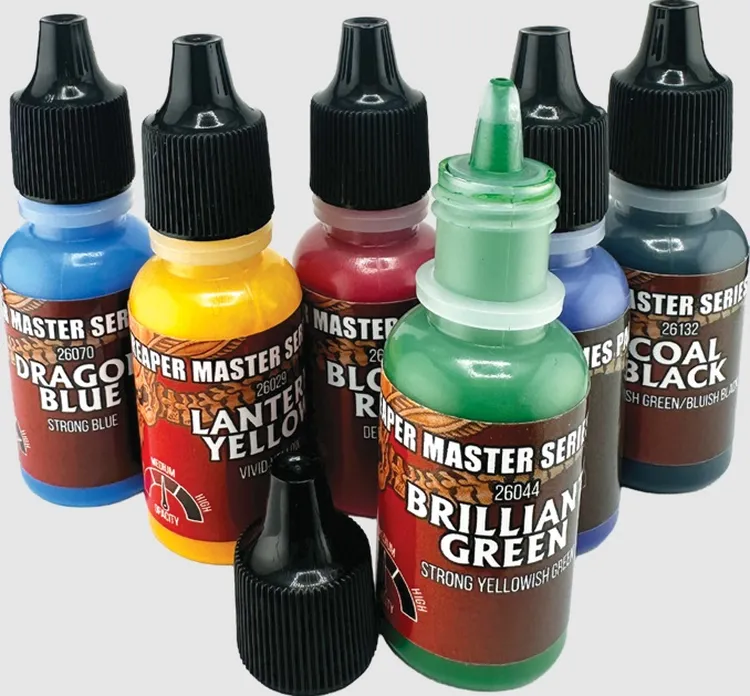 A collection of six paint bottles from the Reaper Master Series Remastered line is displayed, showcasing a variety of vibrant colors. The bottles include shades such as Dragon Blue, Lantern Yellow, Blood Red, Brilliant Green, Coal Black, and a blue variant, each labeled with their respective names and color descriptions. The bottles feature a consistent design with black caps and a prominent label indicating the Reaper Master Series branding.