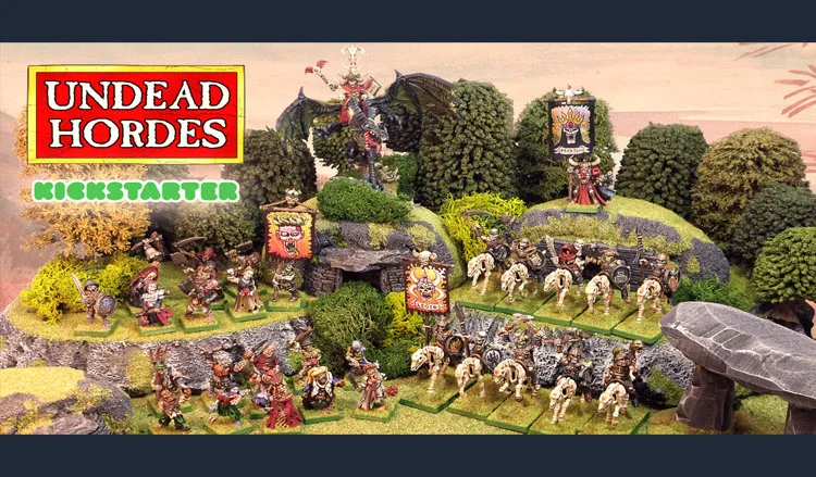 The scene features a vibrant tabletop display showcasing the "Undead Hordes" miniatures from Red Bard Games' Kickstarter campaign. In the foreground, a variety of skeletons and zombies are arranged on grassy terrain, with some holding banners and others in dynamic poses. A prominent liche king rides a zombie dragon atop a rocky outcrop, while additional figures, including a necromancer and various undead warriors, populate the scene, surrounded by lush greenery and stone formations. The overall composition exudes a classic fantasy aesthetic, emphasizing the theme of an undead army ready for battle.