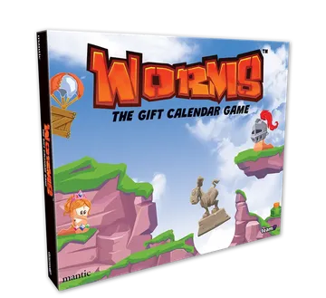 A colorful box for "Worms: The Gift Calendar Game" features a vibrant illustration of cartoonish landscapes with green hills and rocky cliffs. Prominent characters include a pink worm wearing a crown and a knight, both positioned on the cliffs, while a hot air balloon floats in the sky. The title is boldly displayed at the top, emphasizing the festive theme of the advent calendar.