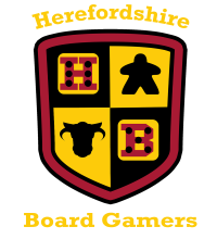 A shield-shaped logo features a divided design with four quadrants. The top left quadrant displays a red die with black dots, the top right features a black meeple, the bottom left shows a black cow silhouette, and the bottom right has a red die with white dots. The text "Herefordshire Board Gamers" is prominently displayed above and below the shield in a bold, yellow font.