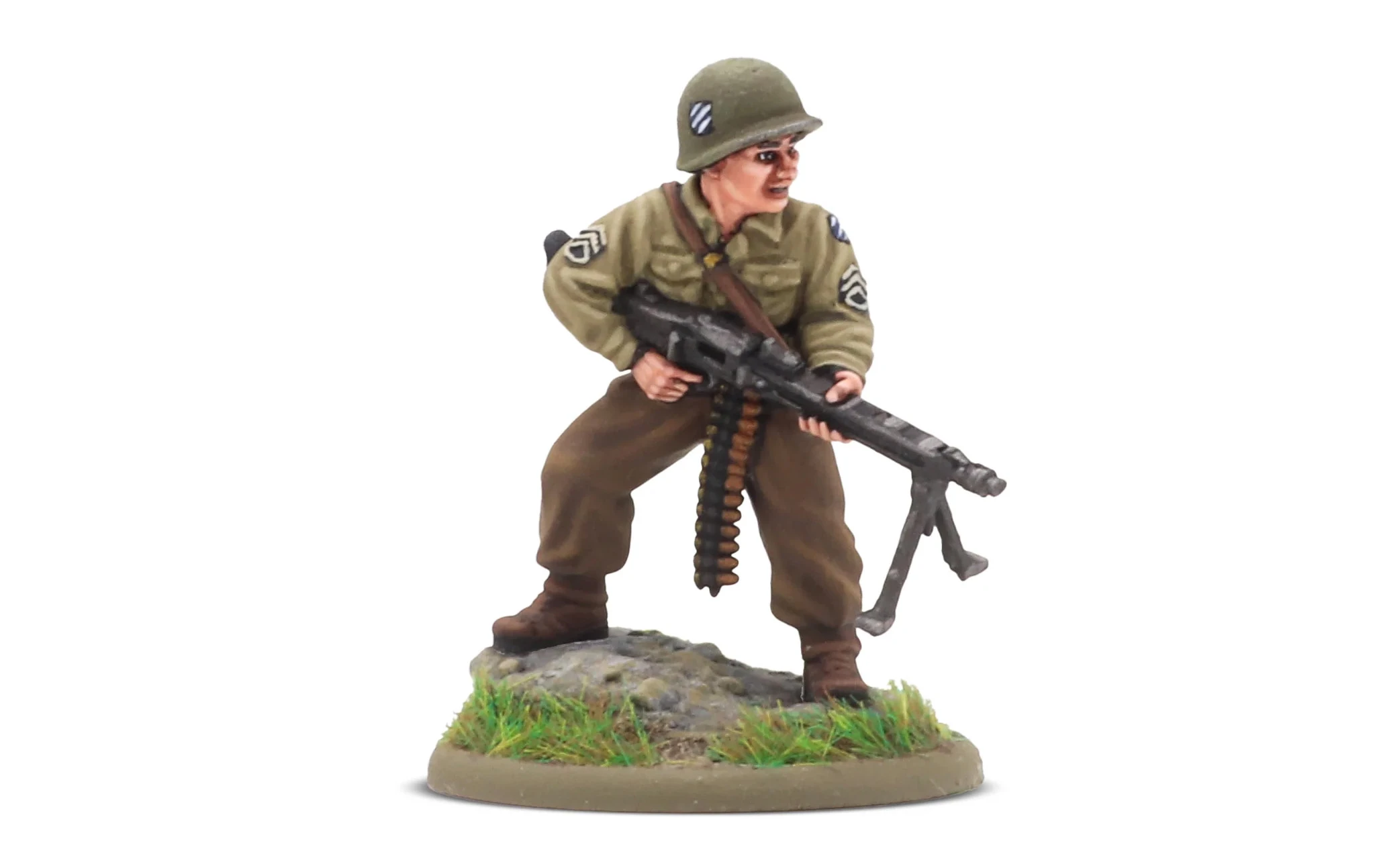 A 28mm scale miniature of a soldier, representing the war hero Audie Murphy, stands on a rocky base adorned with green grass. The figure is dressed in a light green military uniform with insignia on the sleeves and wears a helmet. He holds a machine gun in a ready position, showcasing a determined expression.