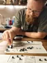 Man rolling dice on Poll & Write Clacton game board.