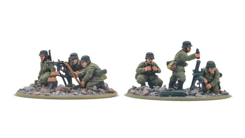 A set of four 28mm scale miniatures depicting German soldiers in various poses. On the left, two figures are crouched behind a machine gun, one operating the weapon while the other observes. On the right, two additional soldiers are shown, one holding a camera and the other preparing to fire a mortar, all set on a base with rocky terrain. The miniatures are detailed and cast in a special resin, showcasing realistic military attire.
