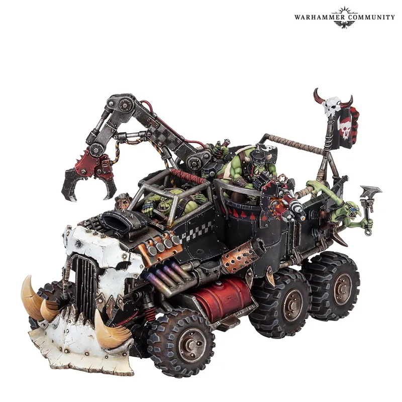 A model of an Ork battlewagon with mechanical arms and green Ork figures.