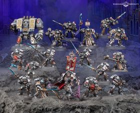 A detailed display of Black Templar miniatures showcases a variety of armored figures in silver and black, set against a dark, rocky backdrop. Prominent in the scene is a Venerable Dreadnought on the left, flanked by a mix of characters including the Emperor’s Champion, Bladeguard Veterans, and Sword Brethren, all wielding swords and other weapons. The figures are intricately painted, with some holding banners and others poised for battle, creating a dynamic and imposing presence.