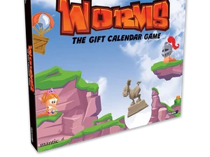 A colorful box for "Worms: The Gift Calendar Game" features a vibrant illustration of cartoonish landscapes with green hills and rocky cliffs. Prominent characters include a pink worm wearing a crown and a knight, both positioned on the cliffs, while a hot air balloon floats in the sky. The title is boldly displayed at the top, emphasizing the festive theme of the advent calendar.