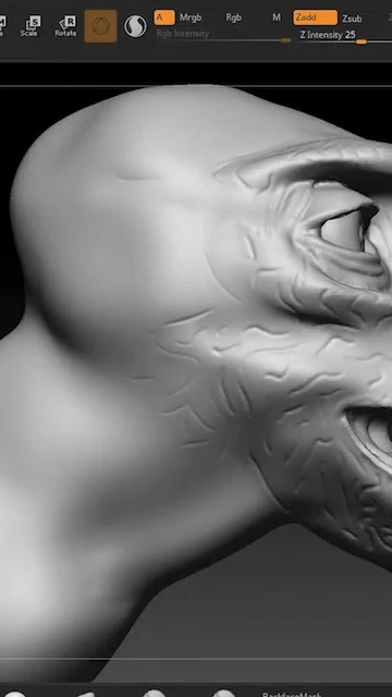 A close-up view of a digital sculpting project in ZBrush, showcasing a stylized dinosaur head. The model is primarily in a gray, untextured state, highlighting the intricate details of the scales and facial features, including a prominent eye and sharp teeth. The interface of ZBrush is visible at the top, displaying various sculpting tools and settings.