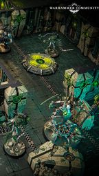 A detailed tabletop gaming scene features a futuristic battlefield with intricate terrain and structures. In the foreground, two armored figures wielding weapons stand ready, while several robotic Necron warriors are positioned strategically among the ruins. The environment is characterized by dark green and metallic colors, with glowing elements and a circular control panel in the center, enhancing the sci-fi atmosphere.
