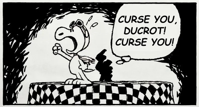 A cartoon illustration features a character resembling a small, anthropomorphic dog with a large head and expressive eyes, wearing aviator goggles and a scarf. The character stands on a checkered platform, dramatically shouting the text "CURSE YOU, DUCROT! CURSE YOU!" in a speech bubble. The background is dark and abstract, enhancing the character's emotional expression.