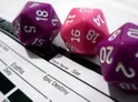 Photo of 3 d20 dice and part of a character sheet