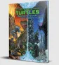 Cover of Teenage Mutant Ninja Turtles: Transdimensional Adventures book. Title in bold green and yellow text. Four turtles in futuristic armor fighting giant robots and dinosaurs in a ruined cityscape with glowing energy effects.
