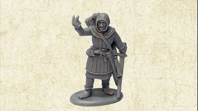 A grey resin miniature of the Master Fletcher stands on a circular base, depicted in a friendly pose with one hand raised in a gesture. He is dressed in a hooded cloak and tunic, with a quiver of arrows slung over his shoulder and a sword at his side. The background features a textured, light-colored surface that enhances the focus on the figure.