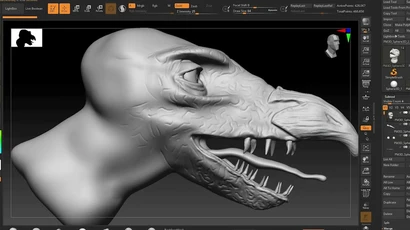 A close-up view of a digital sculpting project in ZBrush, showcasing a stylized dinosaur head. The model is primarily in a gray, untextured state, highlighting the intricate details of the scales and facial features, including a prominent eye and sharp teeth. The interface of ZBrush is visible at the top, displaying various sculpting tools and settings.